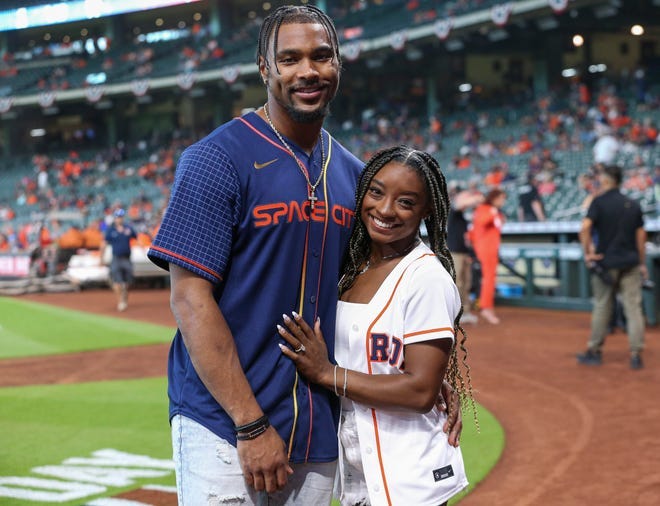 Gymnast Simone Biles and Houston Texans defensive back Jonathan Owens pose for a picture before a Houston Astros game on April 18, 2022.