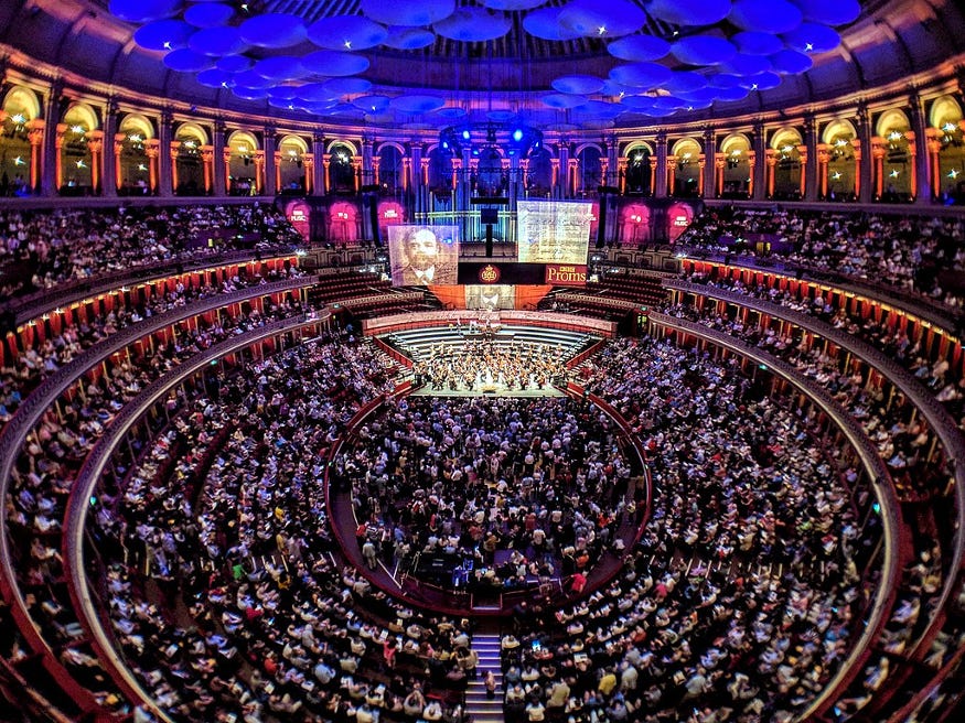 The interior of the Royal Albert Hall with an audience watching the stage