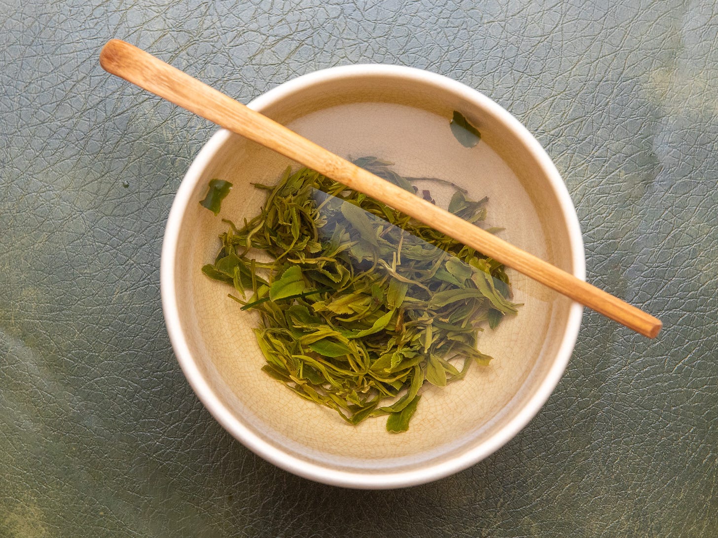 ID: Mao feng green tea brewing in a bowl