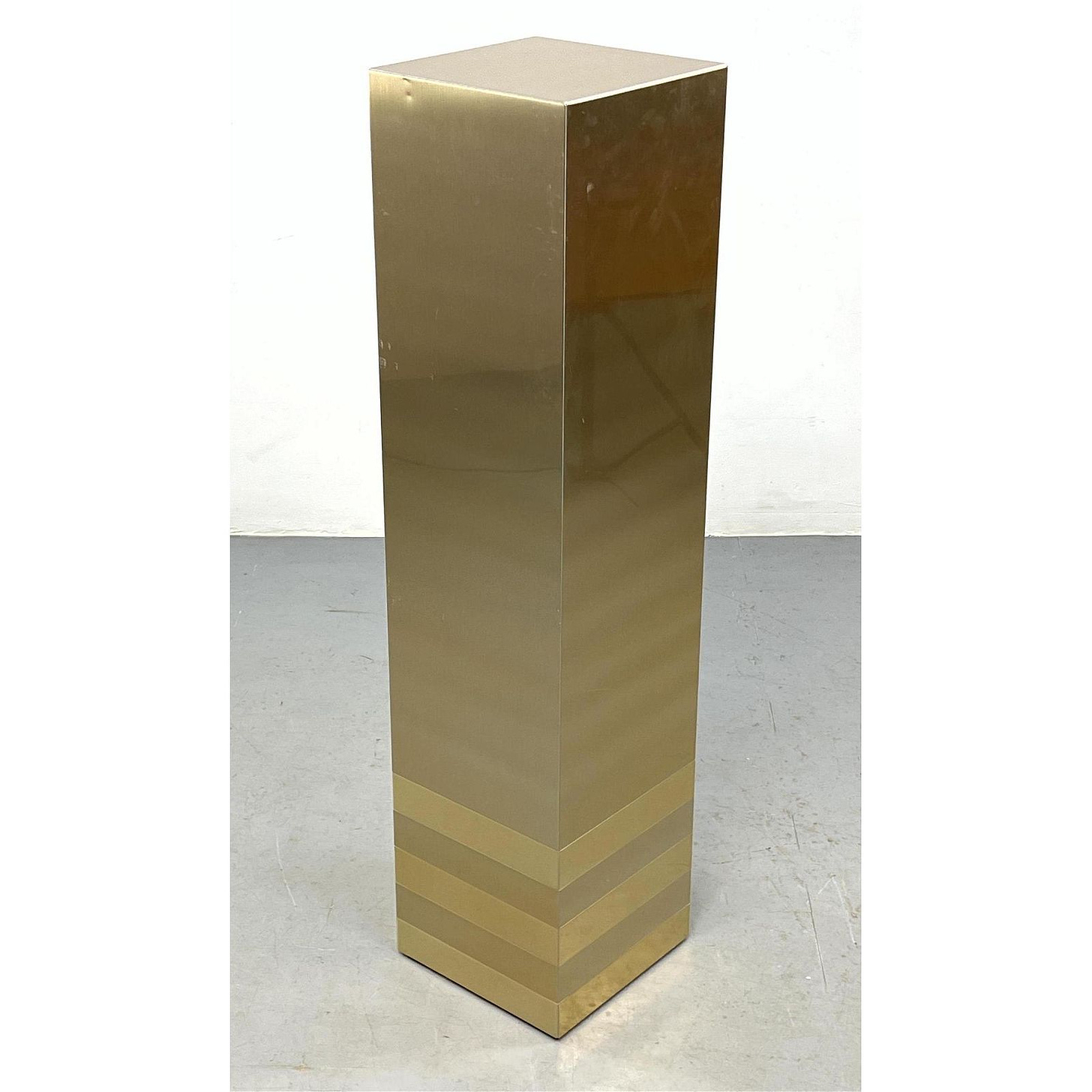 1981 Tall Satin Finish Metallic Display Pedestal. Gold tone with contrasting stripe trim around bott