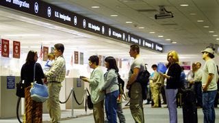 A line of people at an immigration office