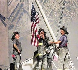 Part of a sequence of photos of three NYC firemen raising a flag at Ground Zero taken on 9/11 of the terrorist attacks that brought down the World Trade Center Twin Towers.