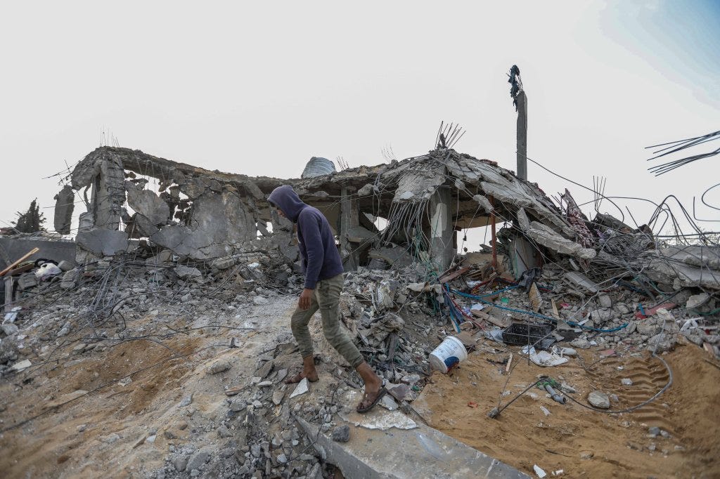 People in Rafah, Gaza inspecting damage and recovering items from their homes following Israeli air strikes on March 26, 2024