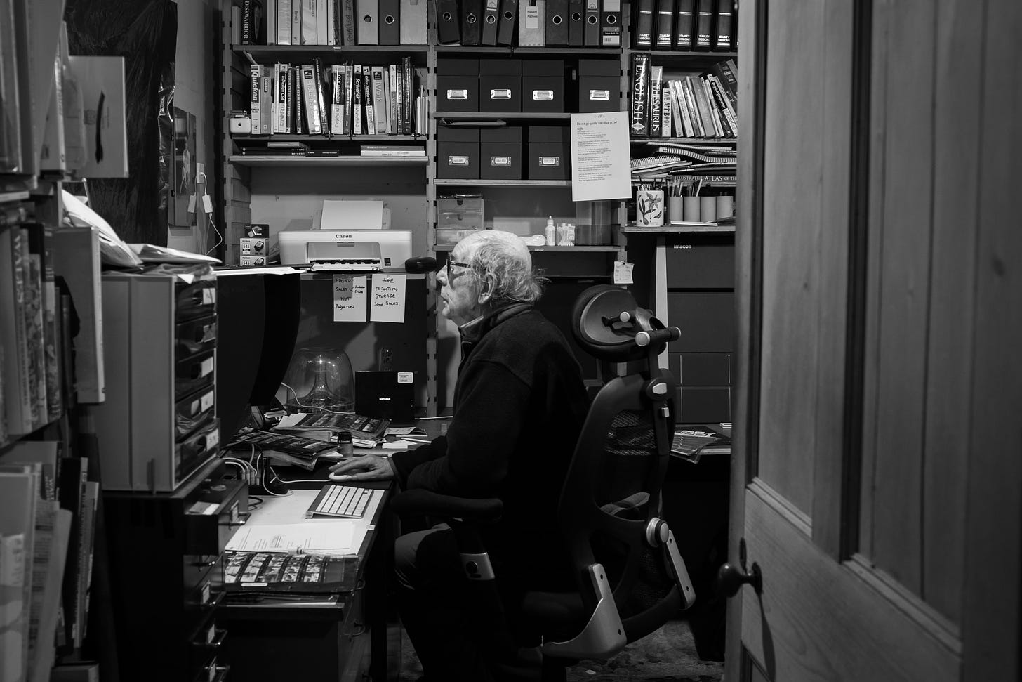 Magnum photographer David Hurn sits in a cluttered office. 