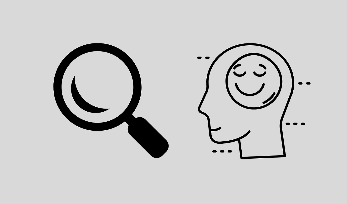 On the left a graphic of a magnifying glass and on the right a graphic of a head with a smiley face for a brain.