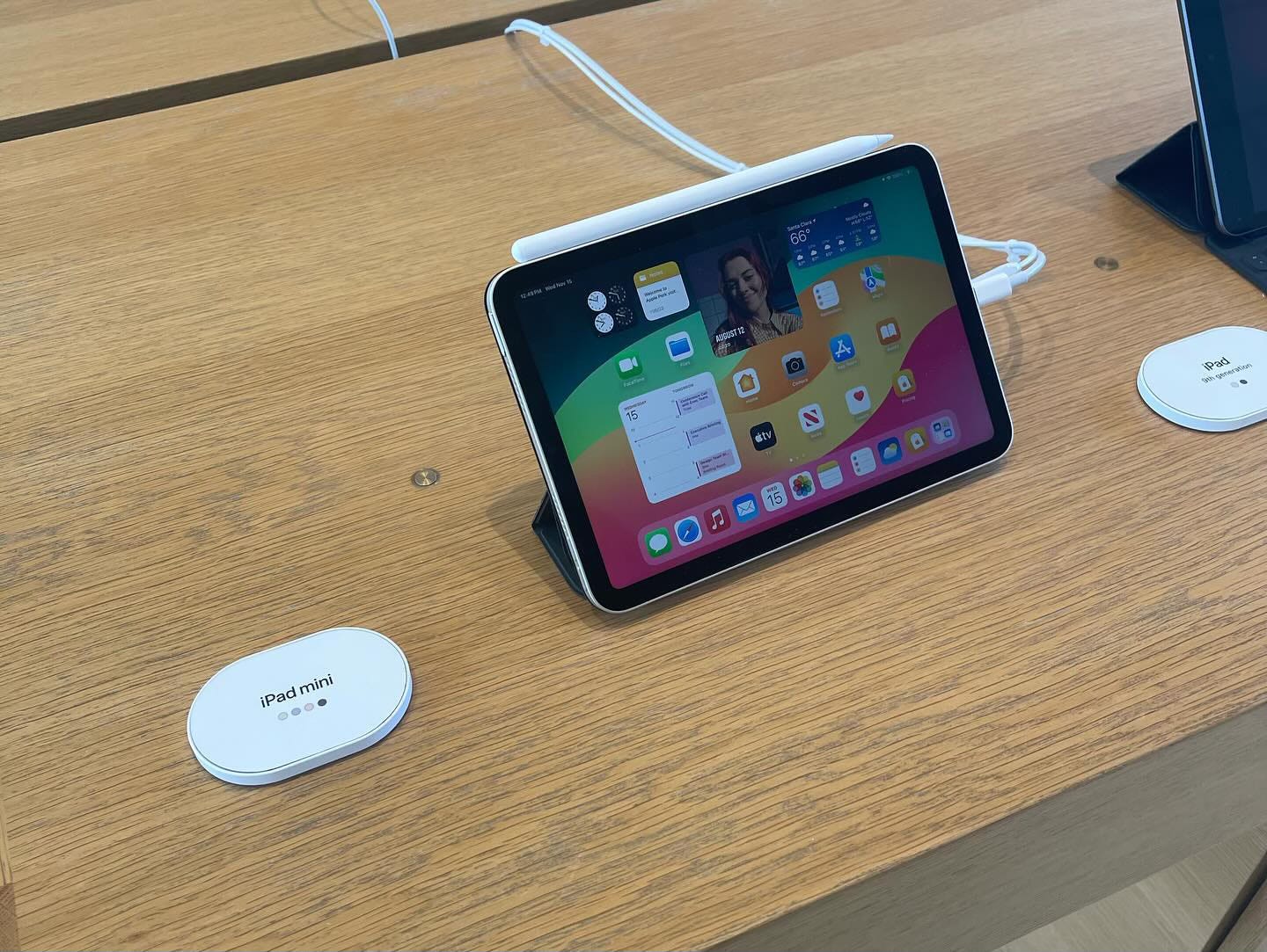 The iPad table at Apple Park Visitor Center. Each iPad sits next to a white tag detailing the model and available colors.
