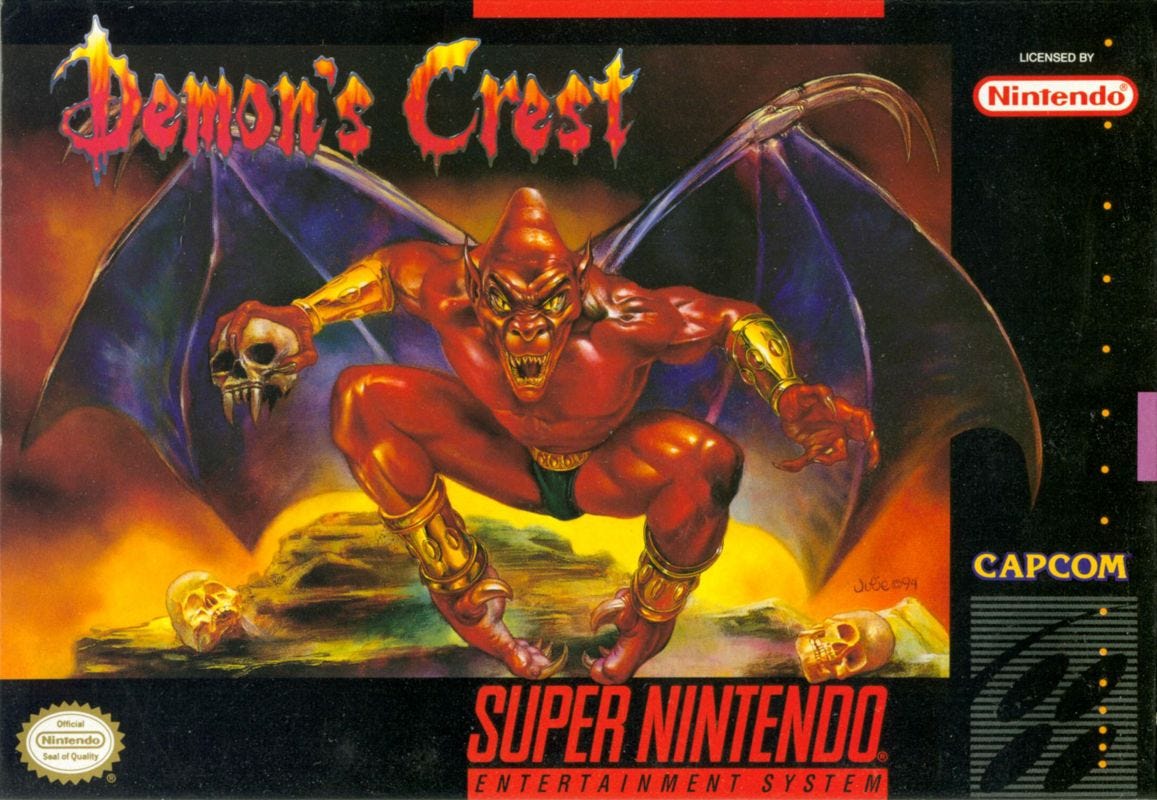 A scan of the SNES box art for Demon's Crest, featuring the game's protagonist, holding a skull in one hand and with golden sleeves on his arms and legs. Wings spread, teeth bared, at the center of the image. "Demon's Crest" is shown above in a stylized font made to look like fire.