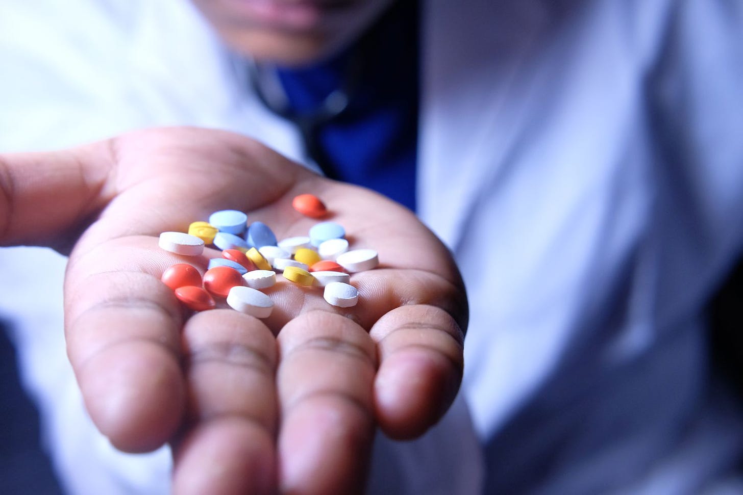 Person holding a handful of antidepressants