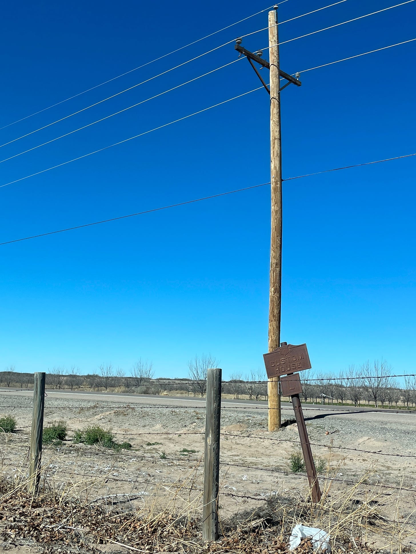 An iron US Customs House sign on the side of the road in Tornillo, Texas