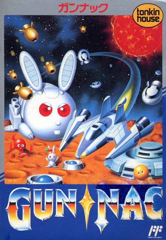 An image of the Japanese cover art for Gun-Nac, which features a wider variety of the game's odd enemies than the North American art, including the rabbit mecha from stage one.