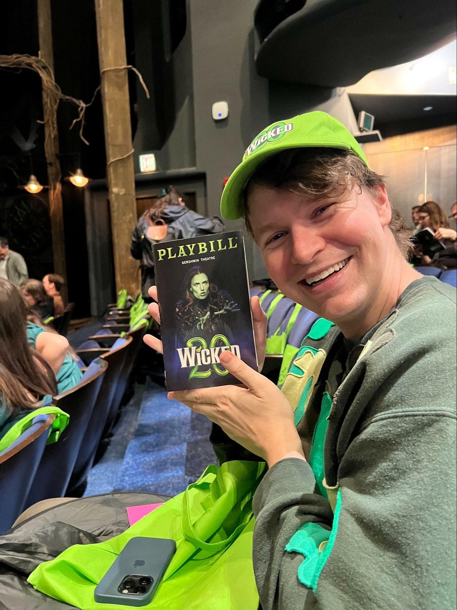 Zach Zimmerman holds up his playbill at Wicked