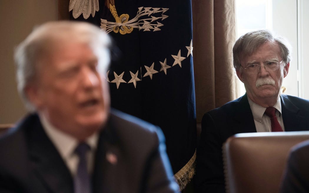 (FILES) In this file photo taken on April 9, 2018 New National Security Adviser John Bolton(R) listens to US President Donald Trump speak during a cabinet meeting at the White House in Washington, DC.