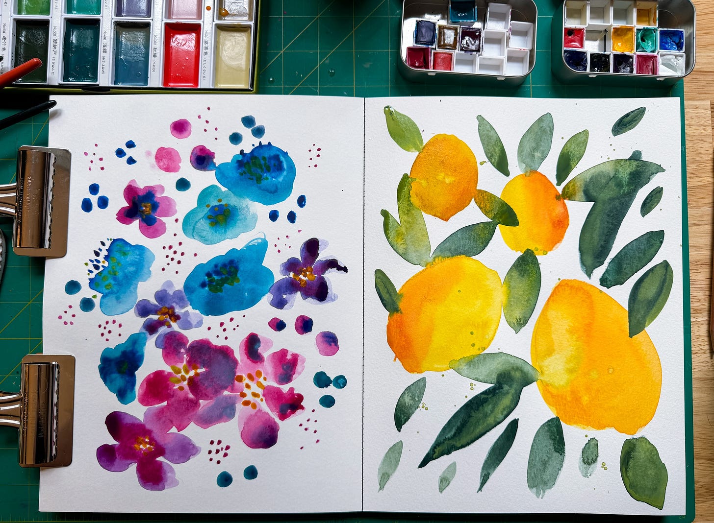 sketchbook spread with loose water color florals on one side and loose watercolor lemons on the other side