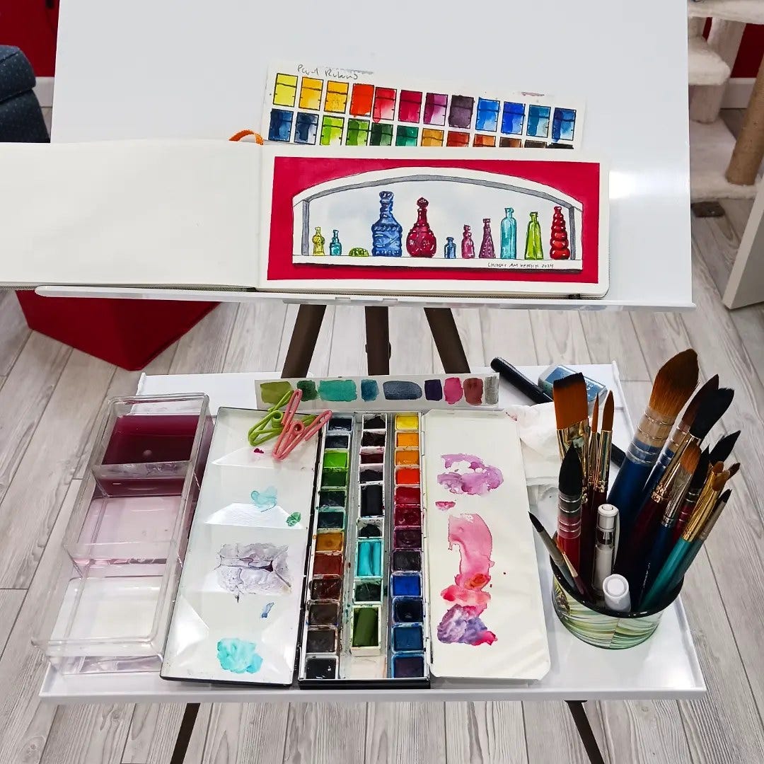 an easel with a small painting of colorful bottles on it.