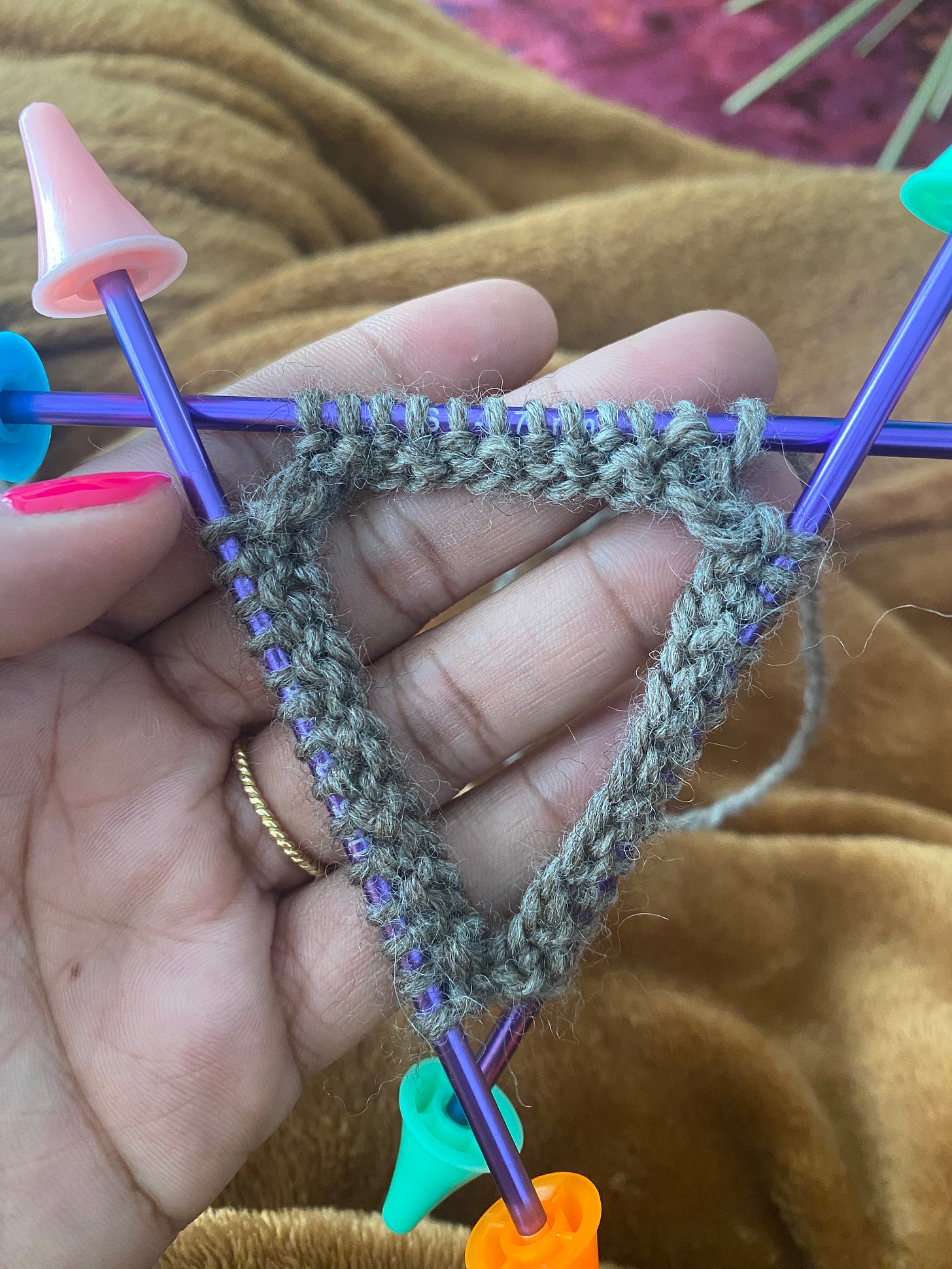 Three double point needs with knit stitches in the round