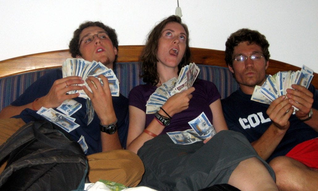 Holding $50 USD each (in Laos currency) with my buddies Keif and Blythe in 2005. #poortravelingstudent