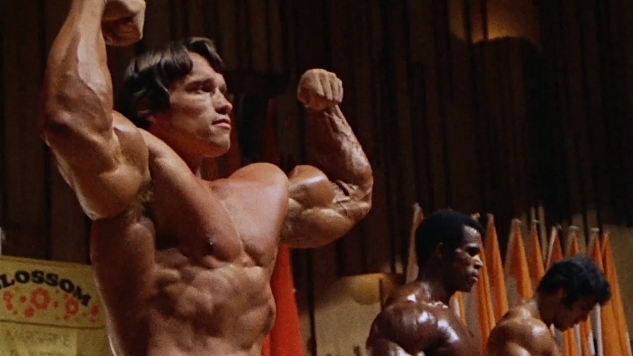 Arnold Schwarzenegger flexes in "Pumping Iron" (1977)
