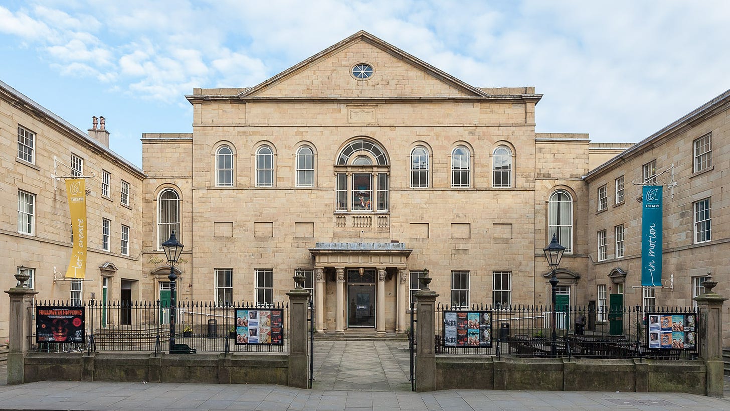 Exterior shot of a neo-classical building and associated symetrical courtyard