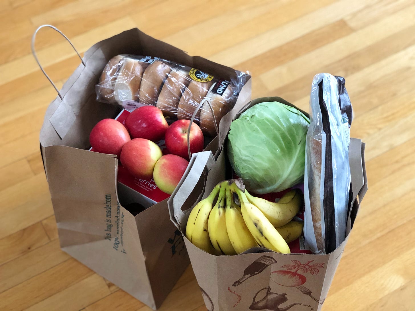Two paper grocery bags with groceries in each bag