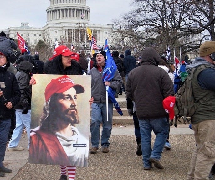 The image of a white Jesus is carried during the Jan. 6, 2021, insurrection at the Capitol. (Creative Commons/Flickr/Tyler Merbler)