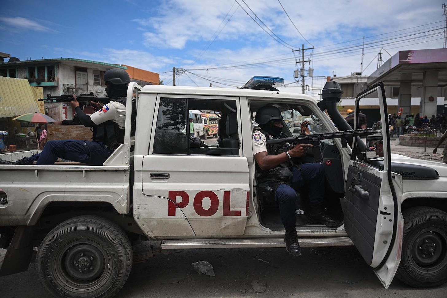 Police officers patrol a neighborhood in Haiti’s capital.
