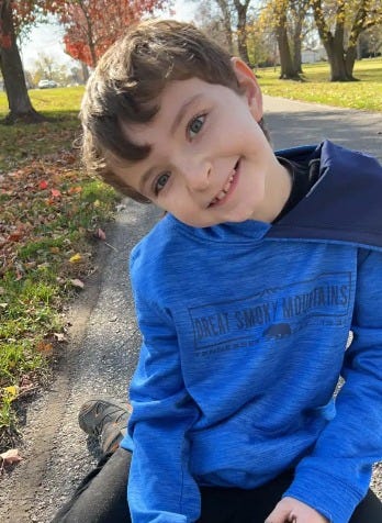 Dakota Stevens, 10, smiling in a blue jacket.