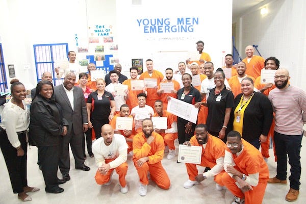 The ceremony for the Young Men Emerging (Y-ME) Unit brought smiles and positive energy to the graduates and the Industrial bank and DC DOC personnel who attended. (Courtesy of DC Department of Corrections)