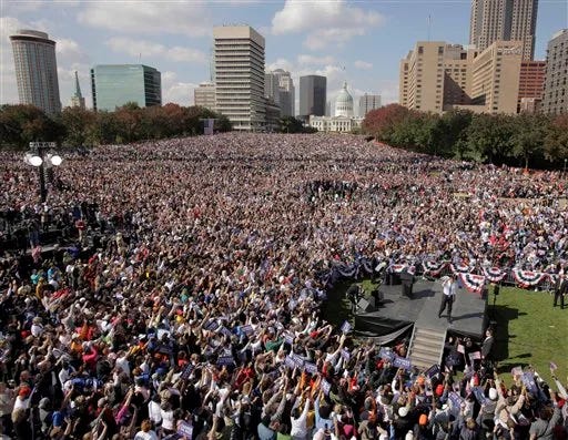 This image shows an 18 October 2008 photo of Barach Obama waving to the estimated 100,000 attendees of a rally held on the grounds of St. Louis, Missouri's Gateway Arch. This image shows an 18 October 2008 photo of Barach Obama waving to the estimated 100,000 attendees of a rally held on the grounds of St. Louis, Missouri's Gateway Arch.