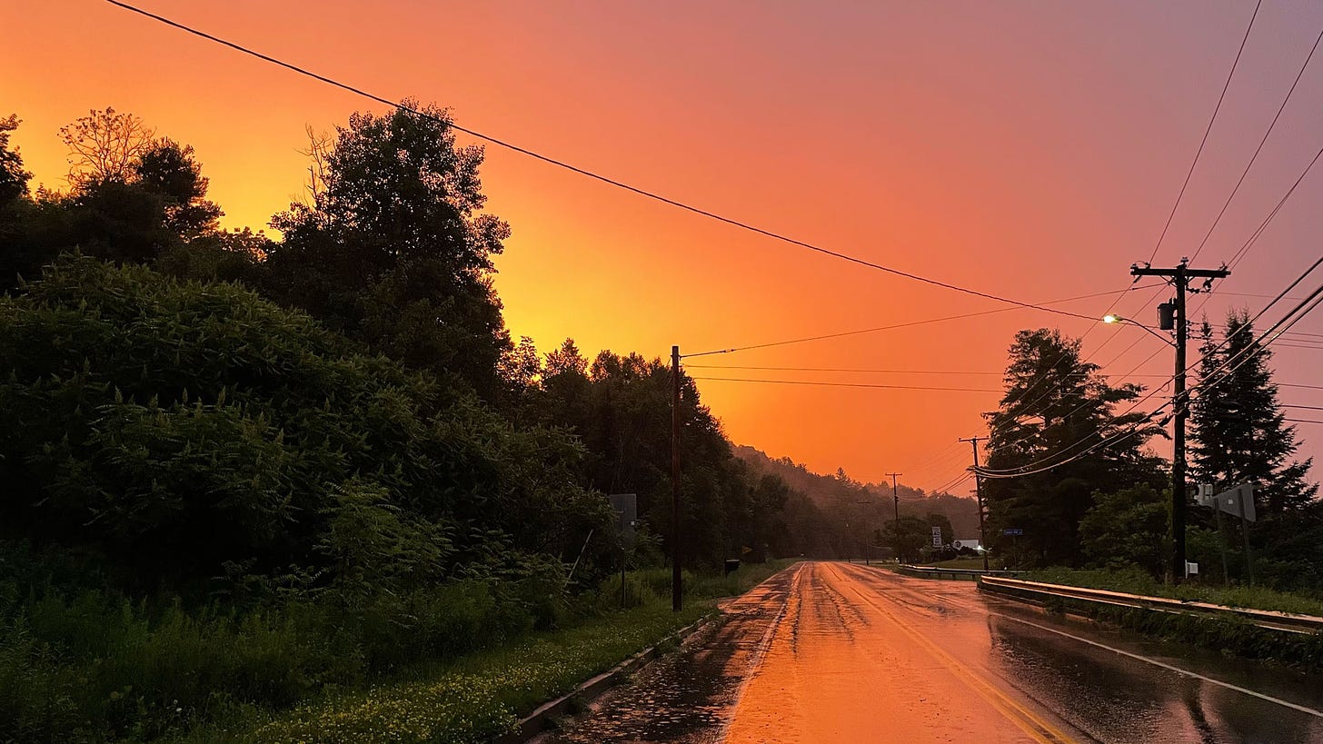Photo of rain soaked road at sunset