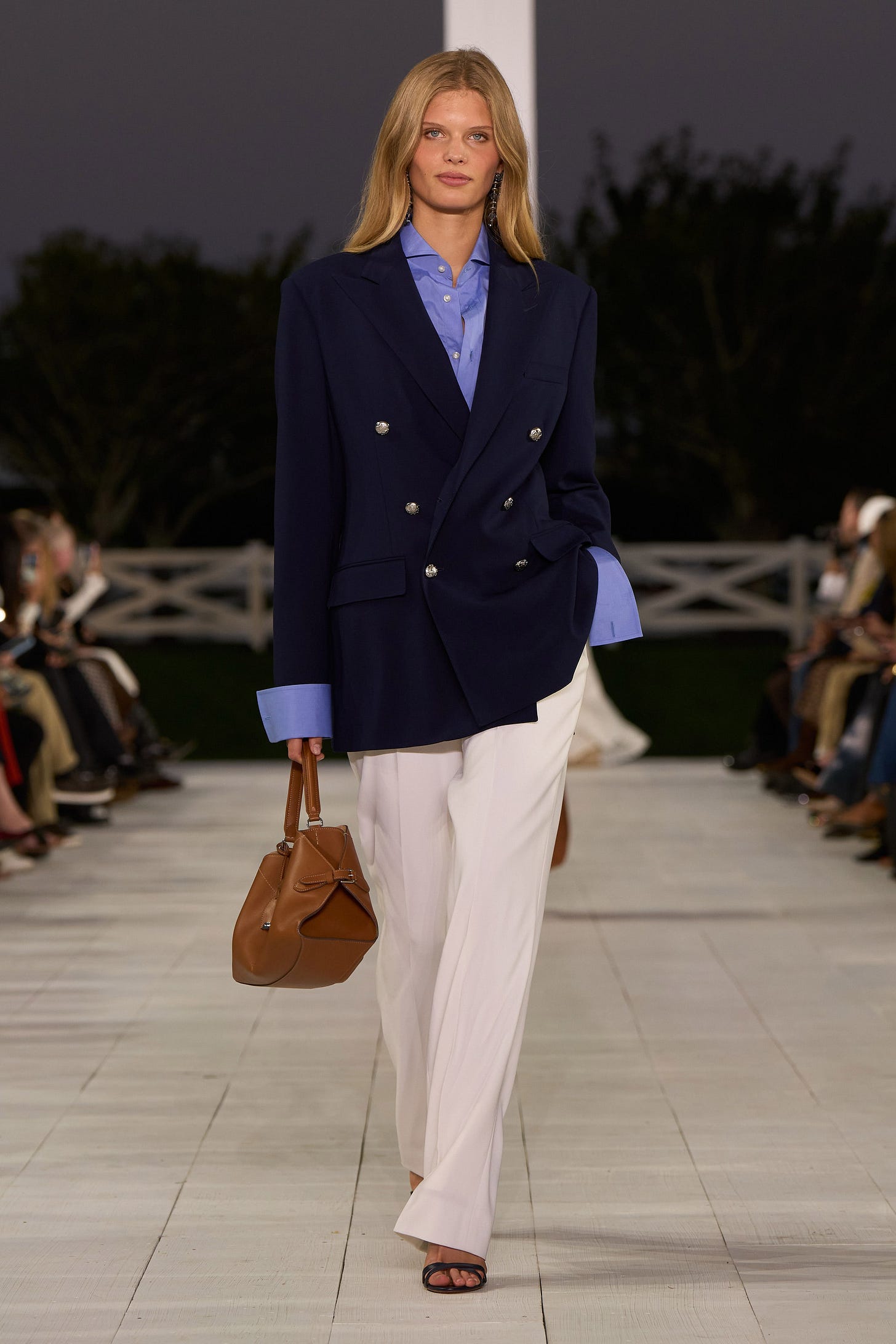 Image may contain Blazer Clothing Coat Jacket Formal Wear Suit Accessories Bag Handbag Pants Purse and Person