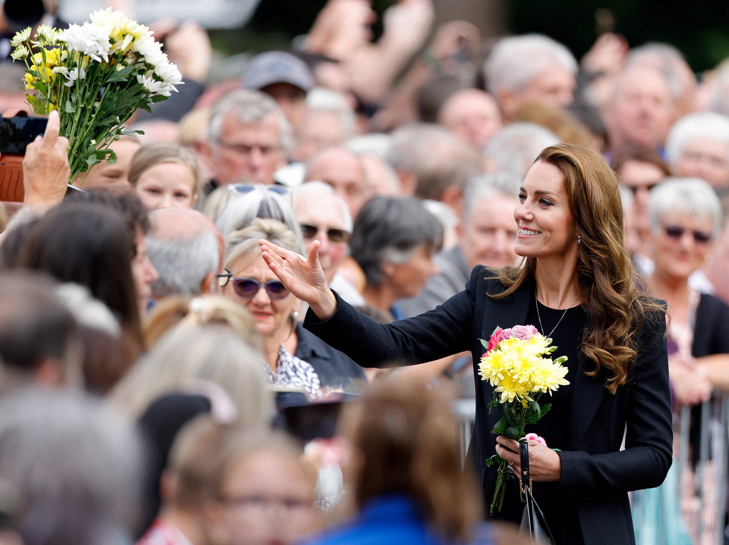 Princess of Wales stretches out her hand to receive flowers