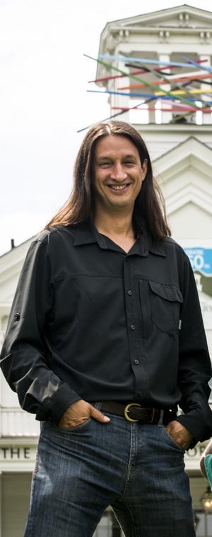 Nathan Suter, former executive director of the Helen Day Art Center (now known as The Current), stands in front of the Stowe gallery in 2016.