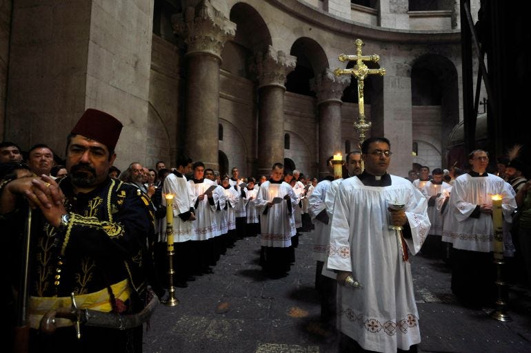 Catholic clergy take part in a procession during Easter Mass at the Church of the Holy Sepulchre in Jerusalem's Old City March 23, 2008