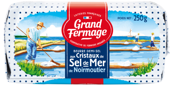 The packaging from Grand Fermage's Noirmoutier sea salt butter, showing men raking sea salt from evaporating ponds on the sunny French coast