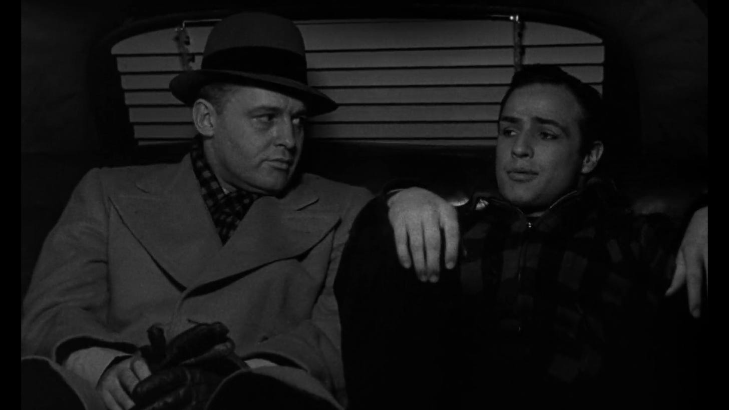 Actors Rod Steiger and Marlon Brando converse in the back seat of a taxi in a scene from the 1954 film On the Waterfront