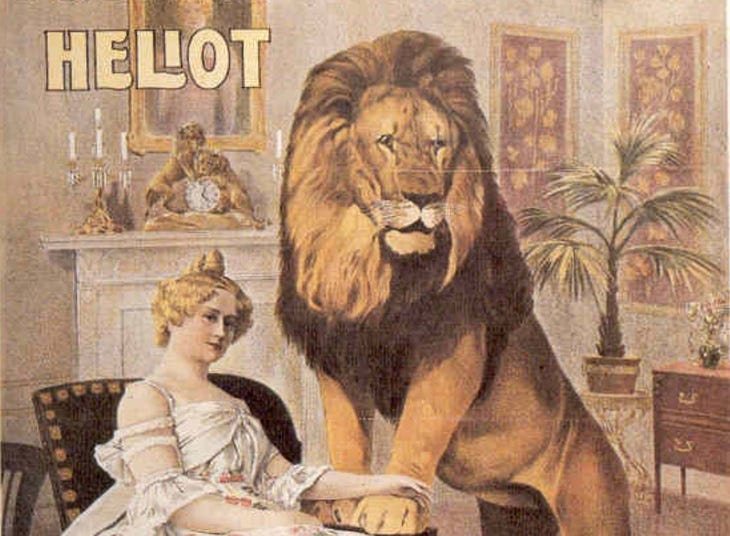 A woman in a sitting room with a lion