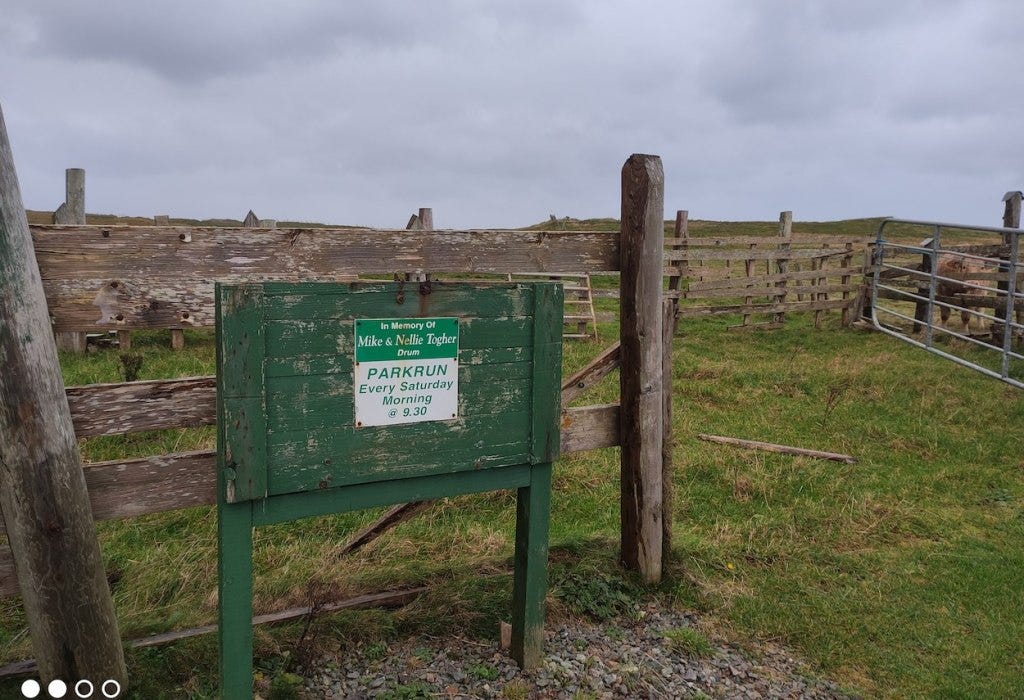 Permanent sign says "In Memory of Mike and Nellie Togher, parkrun every Saturday morning @ 9.30"