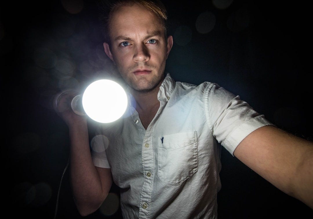 man holding bulb