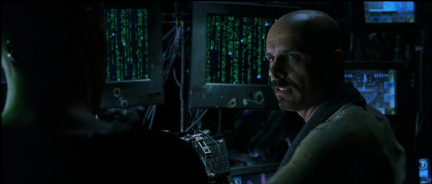 Screenshot from The Matrix (1999). Cypher describes to Neo how what he sees when he looks at screens full of encoded Matrix information is what he finds attractive in what the code represents, not the code itself. Screenshot from The Matrix (1999). Cypher describes to Neo how what he sees when he looks at screens full of encoded Matrix information is what he finds attractive in what the code represents, not the code itself.