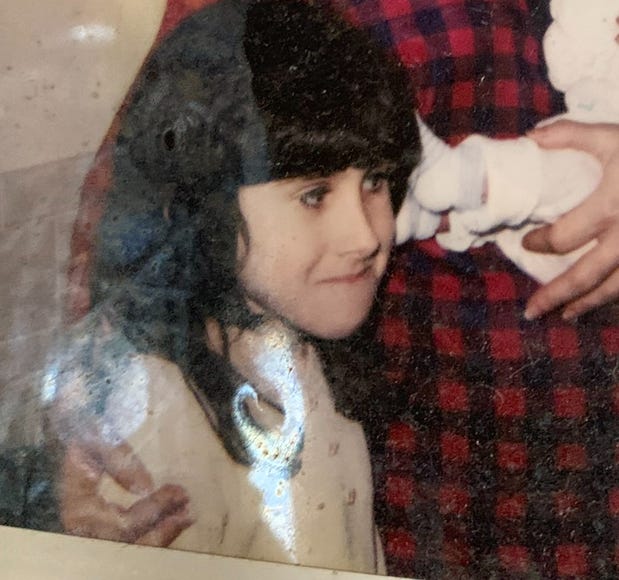 Young Lyric, with long black hair and bangs, makes “a face.”