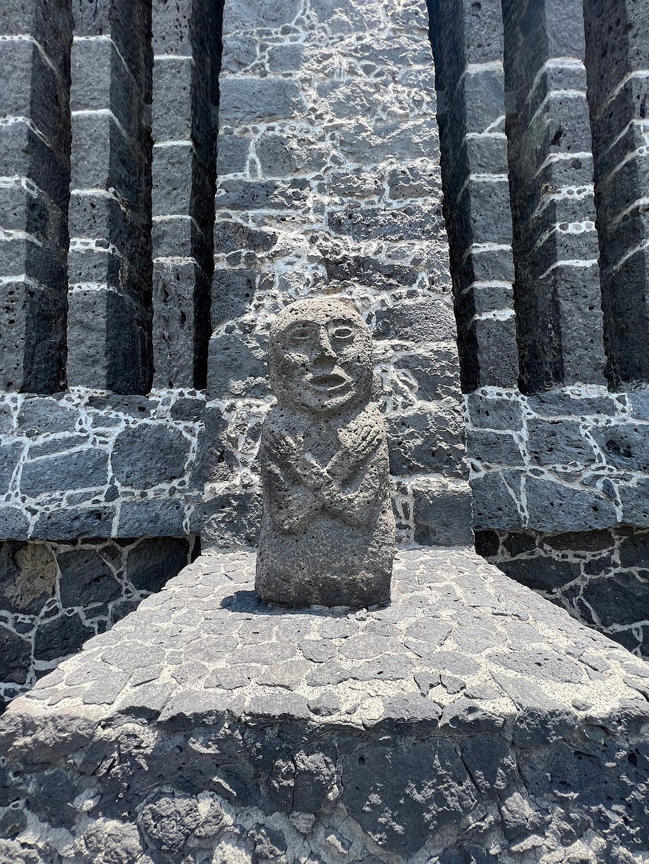 Stone pre-Columbian figure in front of a museum in Mexico City. Stone pre-Columbian figure in front of a museum in Mexico City.