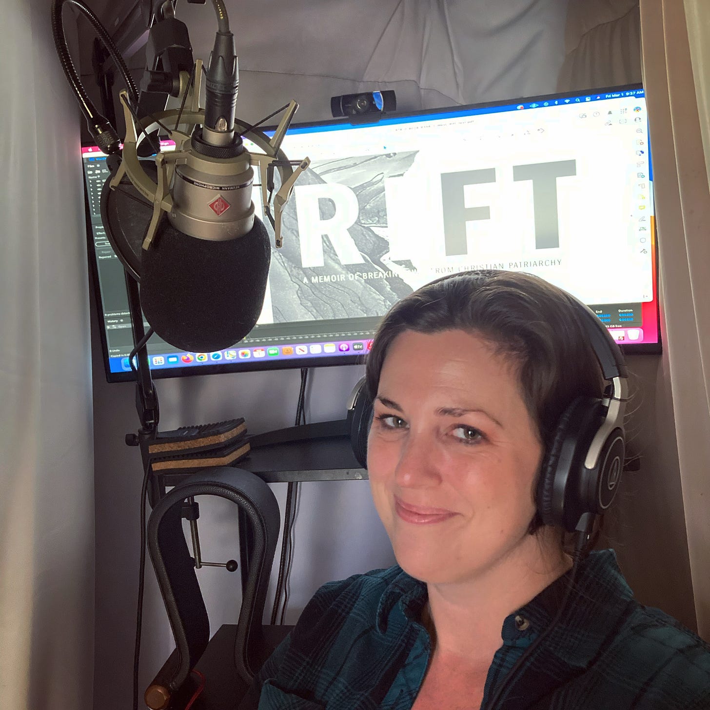 Cait with headphones and a microphone; computer screen that says Rift in the background