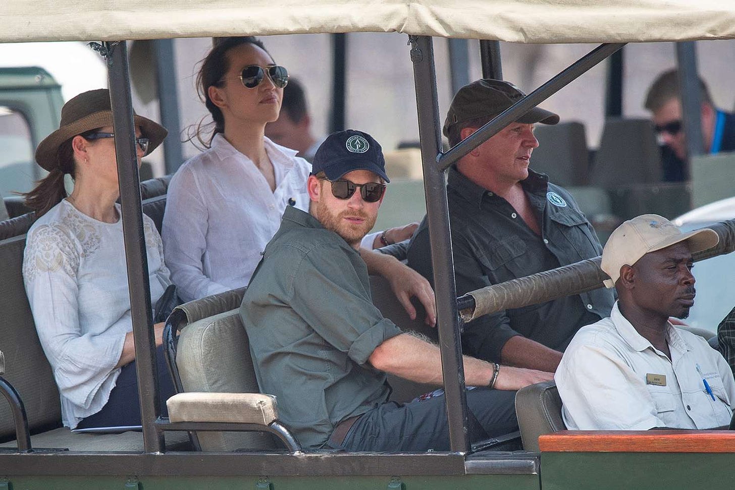 Prince Harry, Duke of Sussex (front centre) arrives by safari jeep to watch an anti-poaching demonstration exercise conducted jointly by local rangers and UK military deployed on Operation CORDED at the Liwonde National Park