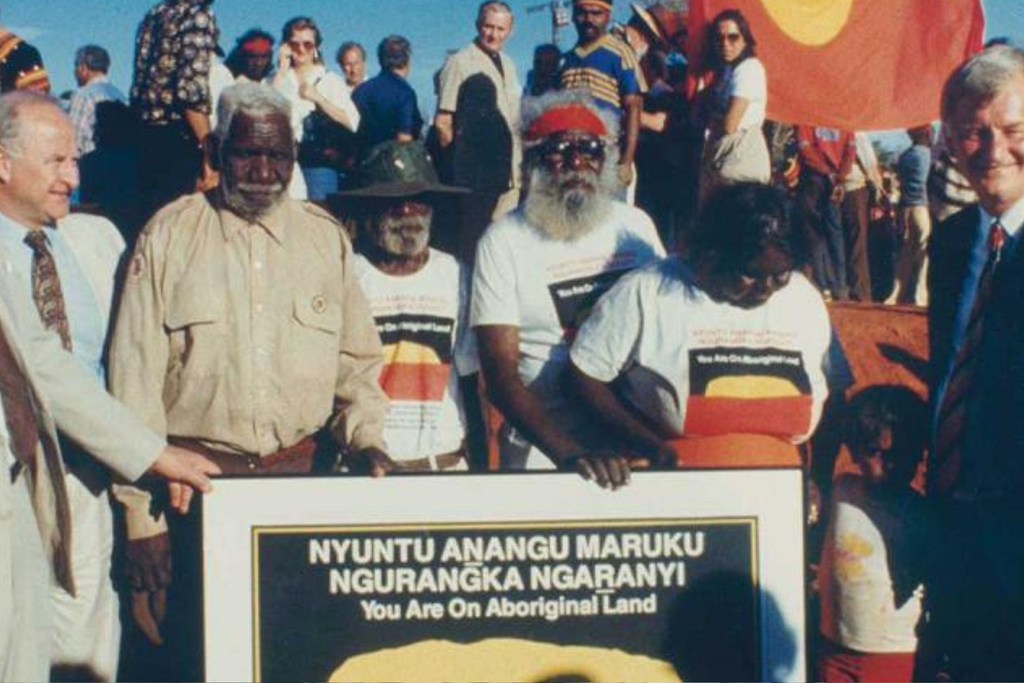 Traditional Owners Peter Bulla, Peter Kanari, Nipper Winmarti and his wife, Barbara Tjirkadu, at the handing back of Uluru in 1985.