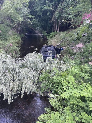 The SUV came to a stop in the McKinstry Brook.