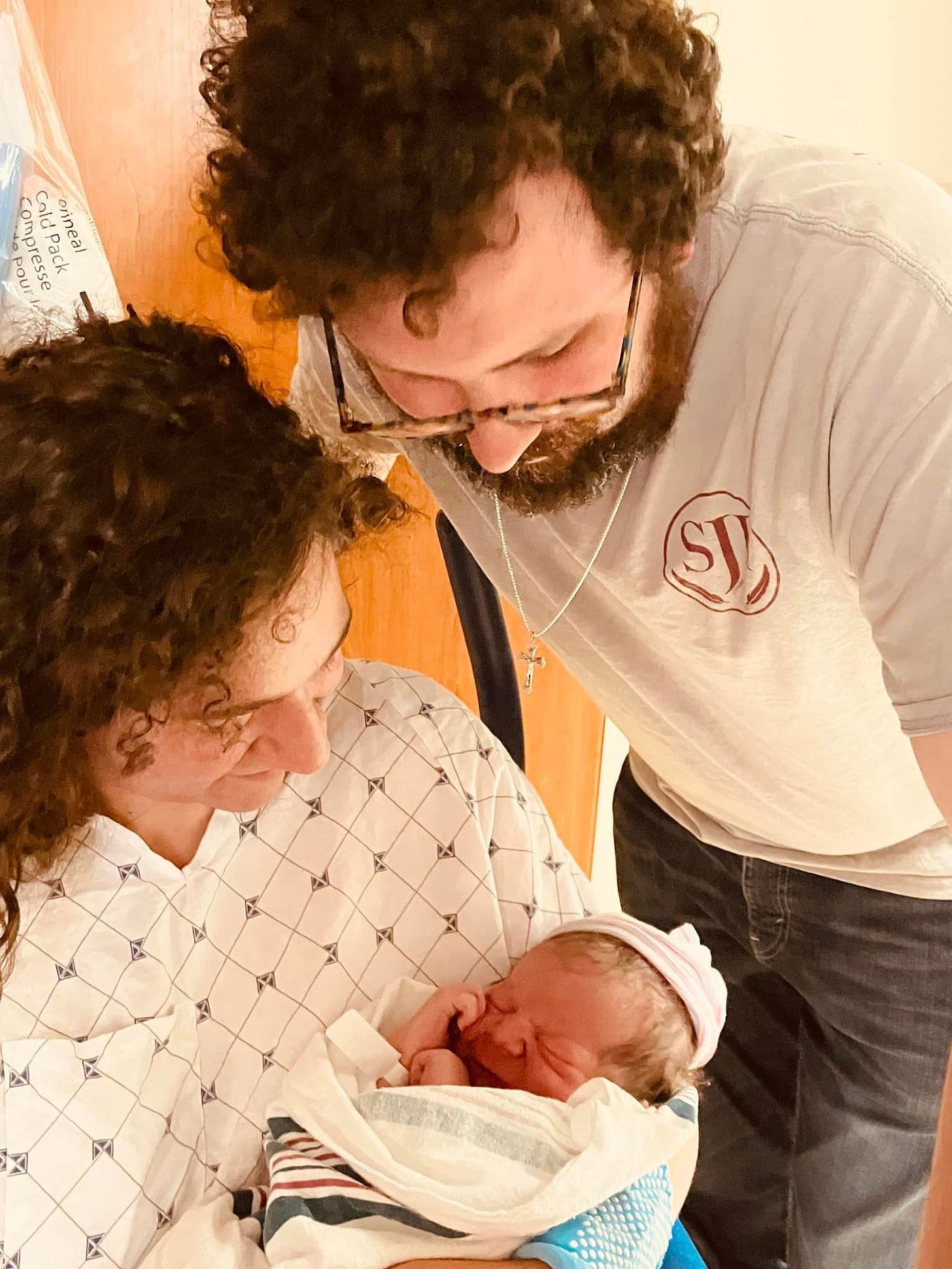 May be an image of 2 people, baby, people smiling and hospital