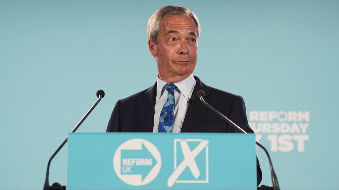 A person in a suit and tie standing at a podium

Description automatically generated
