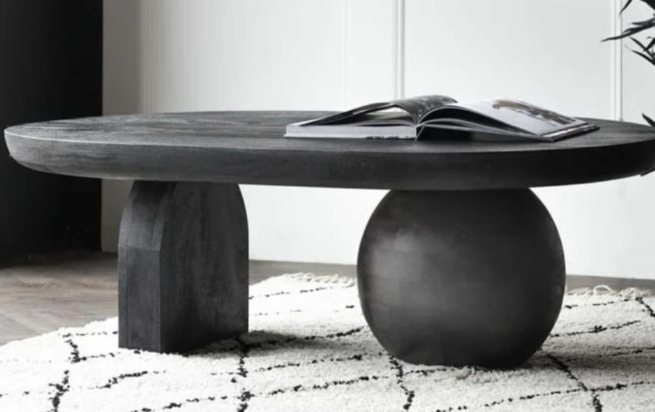 abstract black coffee table with arch and globe legs