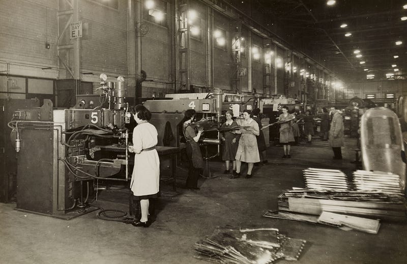 Black and white photo of women working in a factory.