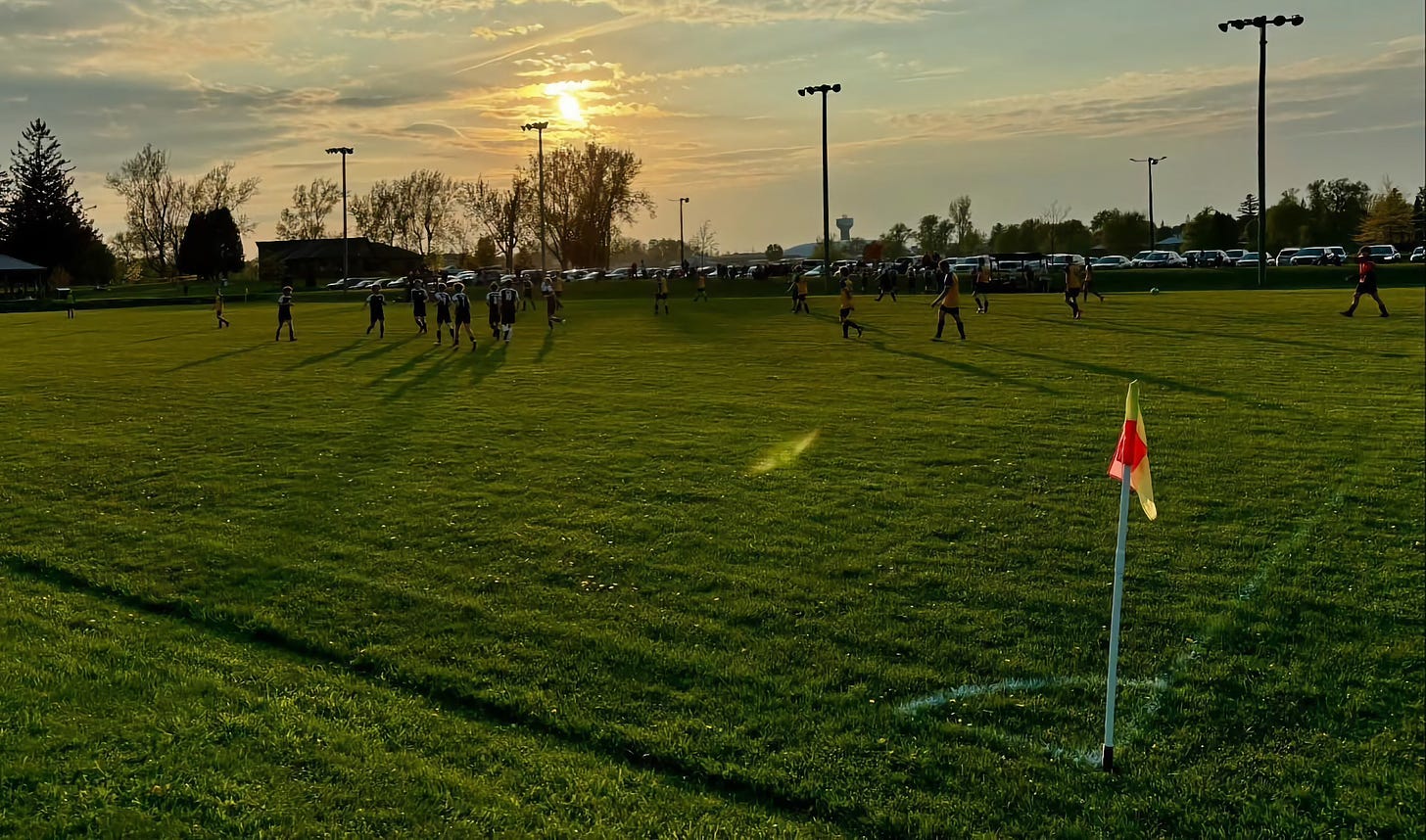soccer action as sun sets